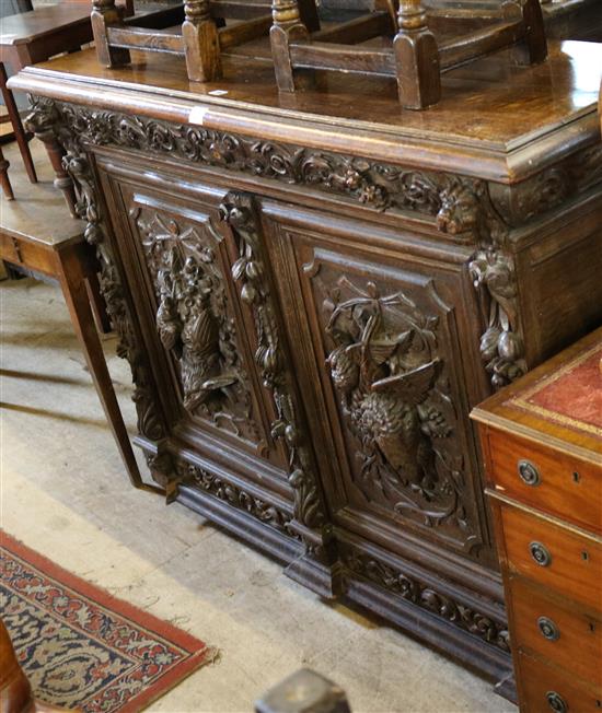 A Victorian carved oak two door cupboard